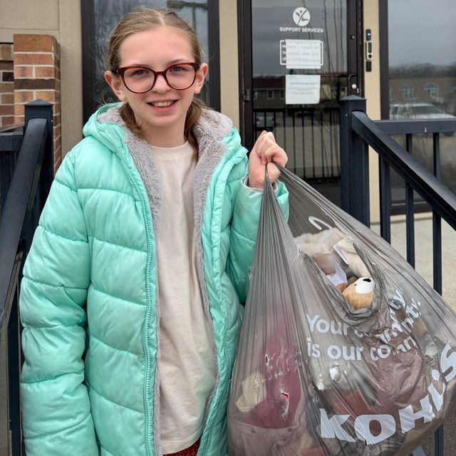 Madilyn with donated baby clothes