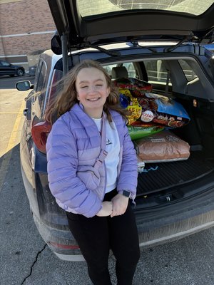 Lily donating dog food to a local food shelter