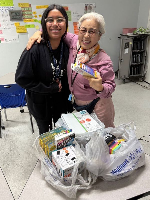 Avylene with her math teacher and the supplies she bought