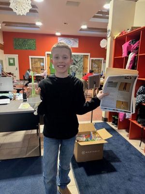 Kaleb donating science project supplies to the Boys and Girls Club
