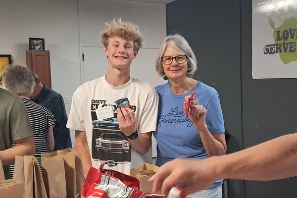 Austin with the summer bags he assembled for people experiencing homelessness