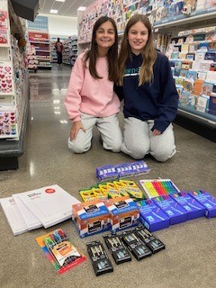 Kaitlyn and a friend with school supplies bought for their teachers at Target