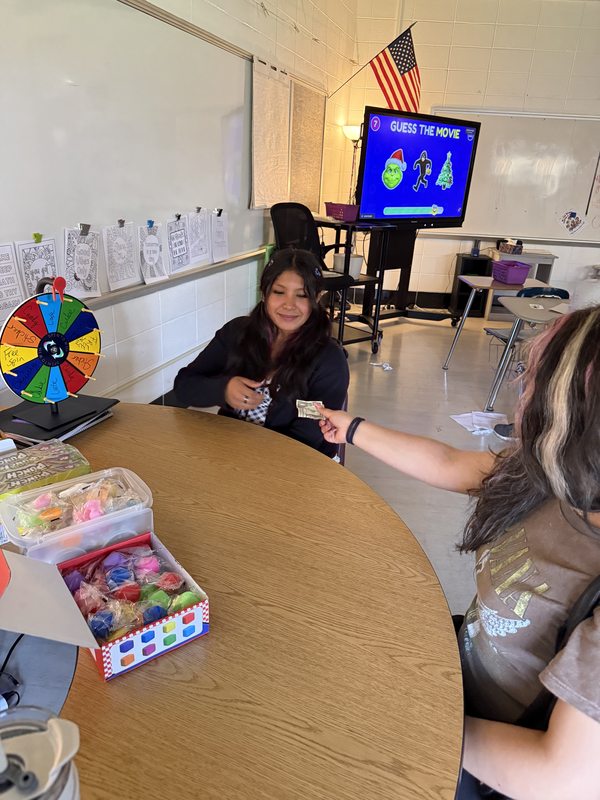 A student spinning for prizes at Kyara's wheel-of-fortune fundraiser
