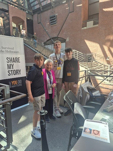 Aiden with classmates and a Holocaust survivor at the "Share My Story" exhibit in Washington, D.C.