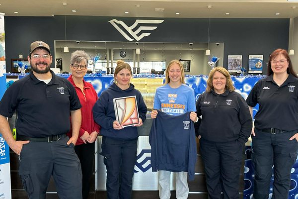 Claire presenting the iPad Air raffle prize alongside members of the Laurel EMS crew
